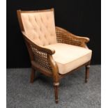 An early 20th century Bergere inspired armchair,
