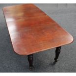A mahogany extending dining table, rounded rectangular top with two additional leaves,