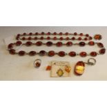 An amber necklace, with twenty oval stones, 60cm long; another, twenty-five stones,