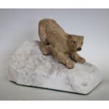 An Austrian cold painted bronze, of a polar bear, tentatively inching down a slope,