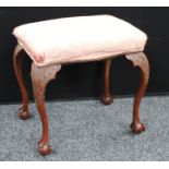 A Queen Anne style stool, serpentine seat, cabriole legs carved to the knees with acanthus,