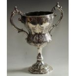 A 19th century Anglo-Indian silver inverted ogee pedestal military presentation cup,