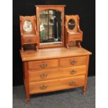 A 20th century dressing chest, adjustable arched bevelled mirror flanked by two, smaller,