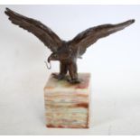 An early 20th century pocket watch stand, cast as an eagle,