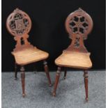 A late Victorian Gothic Revival oak hall chair,
