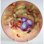 A Royal Worcester circular plate, painted by John Freeman, signed, with plums and cherries,