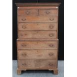 A George III oak chest on chest, outswept cornice above two short and three long graduated drawers,