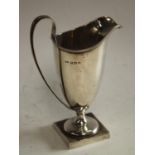 A George V Adam Revival silver helmet shaped cream jug,