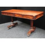 A William IV mahogany library table, rounded rectangular top above a frieze drawer,