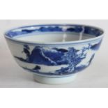 A Chinese porcelain circular bowl, painted in underglaze blue with a stylized panoramic landscape,