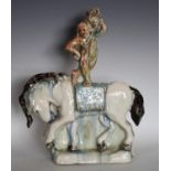 An unusual Art Pottery flatback model, of a water carrier standing on horseback,
