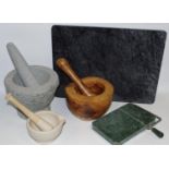 A large stone pestle and mortar 19cm diameter; an olive wood pestle and mortar;