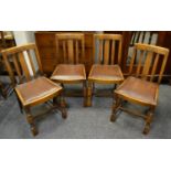 A set of four oak dining chairs with carved top rail