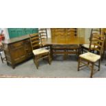 An Ercol dining table with four dining chairs,