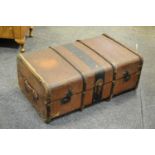 A wood bound travel trunk.