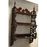 A Gothic Revival mahogany waterfall display rack the pierced supports in the ecclesiastical taste,