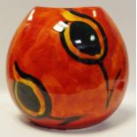 A large Poole Pottery purse vase decorated with an orange glaze, H26cm,