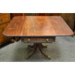 A Regency mahogany Pembroke table, one drawer to frieze with fluted saber legs,brass castors c.