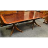 An early 20th century mahogany 7ft twin pedestal dining table with turned column supports,
