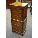 A modern walnut veneered chest on chest, three drawers to top, three to bottom.