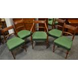 A set of five Regency mahogany dining chairs with one carver, emerald green damask upholstery,