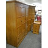 A Grangemoor Priory style bedroom suite comprising triple wardrobe with two long drawers,