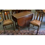 A modern dropleaf table and two 1940's oak dining chairs.