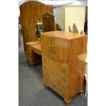 A 1930's walnut bedroom suite comprising double wardrobe, dressing table, tallboy and double bed.