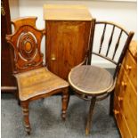 A mid 19th century oak carved hall chair with shaped back,