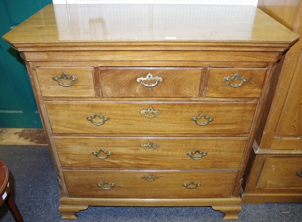 A George III mahogany chest, rectangular top, canted angles,