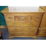 A George III mahogany chest, rectangular top, canted angles,