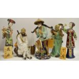 Five oriental figures including an elder holding a dragon chasing the pearl, fisherman,