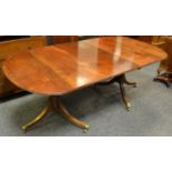 A Regency mahogany twin pedestal D-end dining table, fluted sabre terminating in lion paw feet,