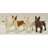 Four model Bull Terriers including a near pair of CH Romany porcelain examples;