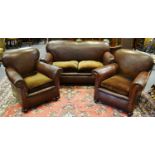 An early 20th century three piece comprising of a drop arm two seater and two tub chairs,