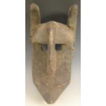 Tribal Art - an Igbo mask, forward-curved ears, ridged forehead with downswept protruberance,