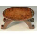 Tribal Art - a Bongo stool or headrest, oval top decorated with brass and copper roundels,