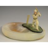 Cricket - a novelty desk tidy, the onyx dish surmounted by a batsman playing a shot, 13.