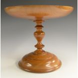 Treen - a turned yew tazza, dished circular top, turned pillar and circular base, 22.5cm high, 26.