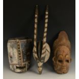Tribal Art - a Bini mask, shaped cresting, narrow features, 34cm long, Nigeria; a Ngbaka mask,