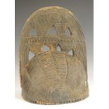 Tribal Art - a Yoruba/Benin helmet, pierced and carved with geometric motifs, 26cm high,