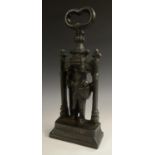 A cast iron door stop, as a chivalric knight, he stands, in armour, within a Gothic arch,