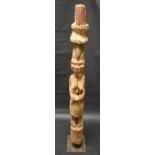 Tribal Art - a large Yoruba figure, she stands, an upturned stool on her head, 142cm high,