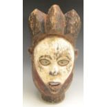 Tribal Art - a Yombe mask, shaped triform cresting, glass inserts to eyes,