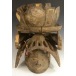 Tribal Art - a Yoruba Gelede helmet mask, lofty cresting, stylised features,