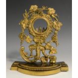 A 19th century gilt metal pocket watch stand, cast with fruiting vine, flowers,