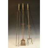 A set of three Baroque steel and brass fire irons, comprising tongs, shovel and poker,