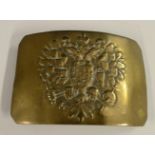 A Russian brass belt buckle, probably military, chased with the Imperial double-headed eagle,
