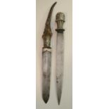 A Tibetan ceremonial dagger, 27cm broad steel blade, white metal incurve-fluted weave grip,