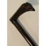 A gentleman's novelty walking cane, the L-shaped handle carved as the head of a bird, 104.